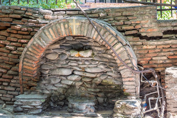 Fresh drinking water fountain from church wall Tbilisi, Georgia.