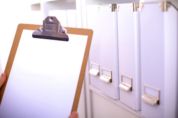 folders with documentation with binders in background