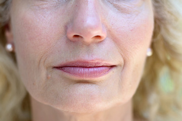 Lower face of a senior lady with a quiet smile