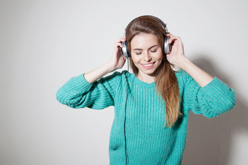 Fototapeta premium beautiful girl listens to music in headphones