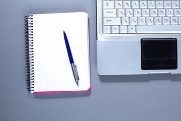 Workplace with notebook laptop Comfortable work table in office windows and city view