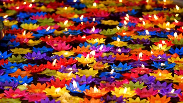 candles lotus colorful on water loop in temple for lucky background, Thailand