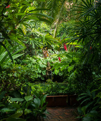 Garden of Jim Thompson House Museum with a Pond and a Woman Statue in Bangkok, Thailand.