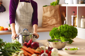 Young Woman Cooking in the kitchen. Healthy Food