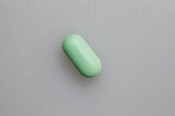 Pills and pill bottle on white background