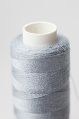 spool of thread and needle isolated on a white background