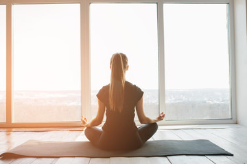 Young beautiful woman practicing yoga and gymnastic. Wellness concept. Classes in single sports.