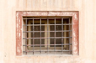 Fototapeta na wymiar Old rustic metal lattice on front of small window