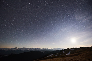 Night sky with stars shining above mountain peak copyspace outdoors camping travelling nature calamity peace harmony galaxy space cloudscape