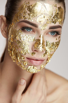 Beauty Gold Mask. Sexy Girl With Golden Mask Touching Body