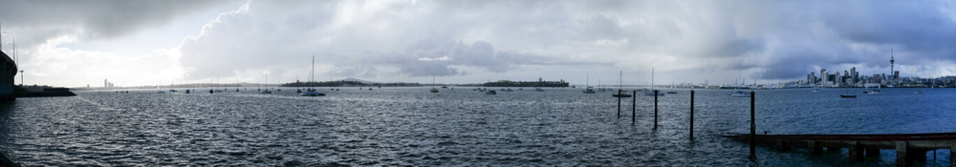 Fototapeta na wymiar Stormy grey cloudy sky over Auckland and Waitemata Harbour in winter