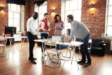 Group of five creative worker brainstorm together in office, new style of workspace, happy scene of people in office