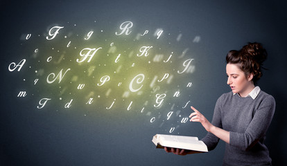 Young lady holding book with letters