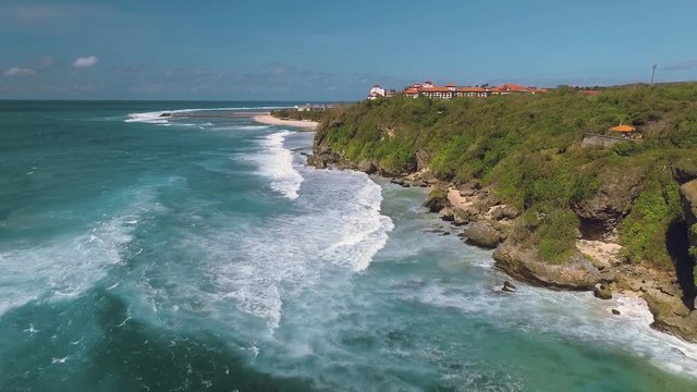 Aerial view of cliff shore in south Bali, moving backwards
