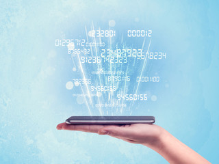 Hand holding phone with digital numbers