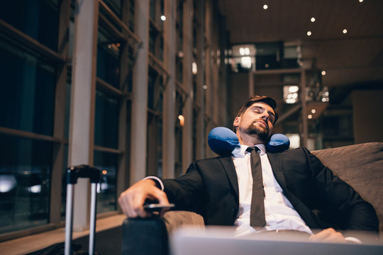 Young businessman asleep in airport lounge