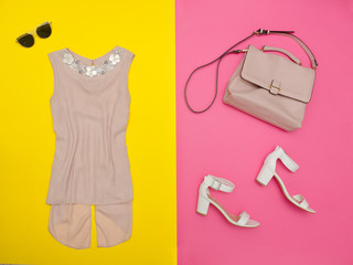 Cream blouse, handbag, white shoes and glasses. Bright pink-yellow background