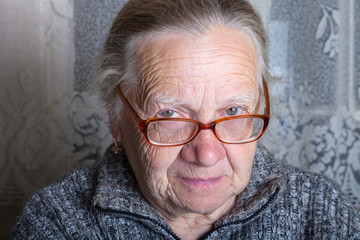 Elderly woman with glasses in rustic interior