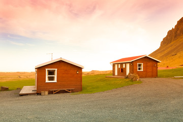 Small wooden house on the shore of the fjord in the east of Iceland. Toned