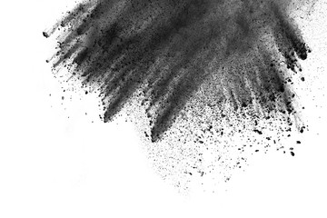 Black powder explosion. Closeup of black dust particles explode isolated on white background.