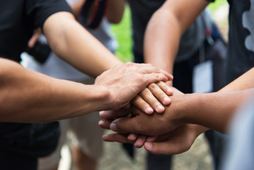 Teamwork concept,Business team standing hands together in the loft office.people joining for...