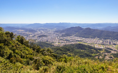 Mountains, the city and the Atlantic Forest: view from the "Morro das Antenas" in Jaragua do Sul, Brazil