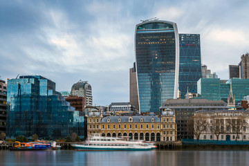 London, England - Panoramic skyline view of the famous Bank district of central London with skyscrapers, boats and blue sky