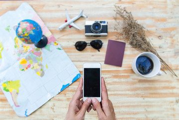 Naklejka na ściany i meble Travel planning concept on map,Flat lay of accessories on wooden desk background of photographer, Voyage concept.