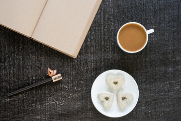Coffee, diary, pencil and heart-shaped cookies