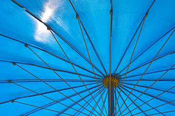 The sun shines through the garden umbrella.