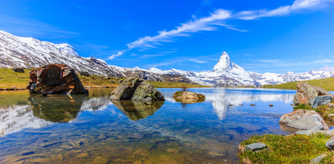 Beautiful panoramic summer view of the Stellisee lake with reflection of the iconic Matterhorn (Monte Cervino, Mont Cervin) and clear blue sky on water, Swiss Alps, Zermatt, Switzerland, Europe - obrazy, fototapety, plakaty