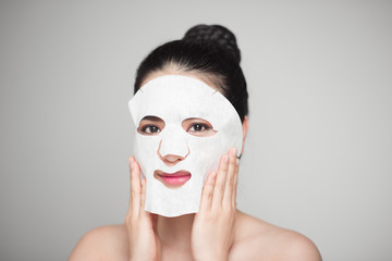 Spa, healthcare. Woman with purifying mask on her face isolated on white background