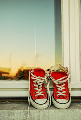 Shoes and sky on window