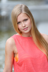 Fototapeta premium Romantic cute and young blonde girl looking at camera. Portrait. Outdoors