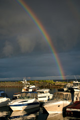 Storm on the sea with a rainbow and yachts
