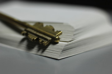 the key to the lock on a blurred background with paper