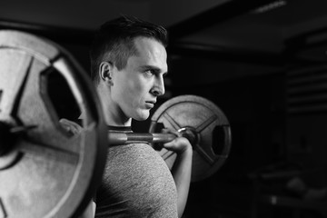 Obraz na płótnie Canvas man with weight training equipment on sport gym club