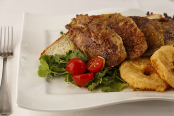 Chicken with breaded pineapple arranged on a plate, Traditional dish in elegant setting, Selective focus with soft light