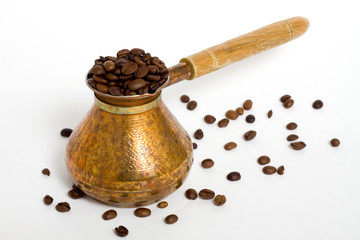 Coffee beans and pot on white