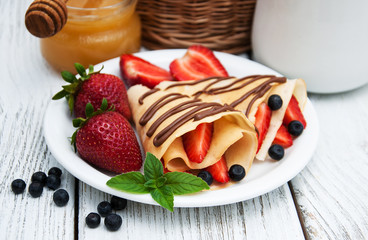 crepes with strawberries and chocolate sauce