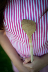 Young housewife with spoon closeup