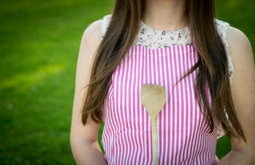 Young housewife with spoon closeup