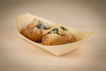 Buns with plum filling and with cottage cheese on wooden table
