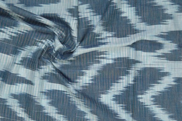 background of silk fabric with oriental ornaments. uzbek silk with ornament