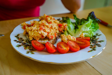 Tasty morning breakfast, omelet, salade, salmon and tomates