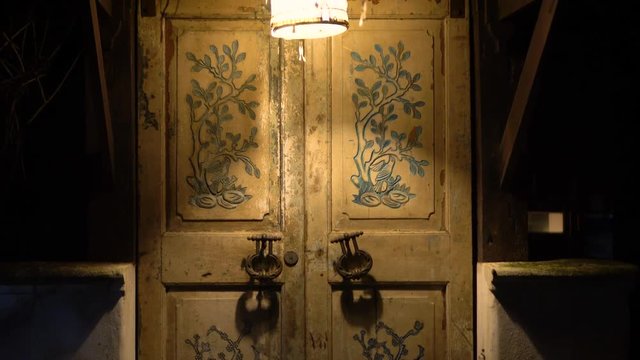An old door with large handles and a in a vintage style.