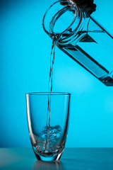 Man pours water from glass