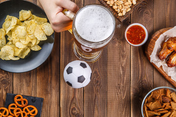 Appetizers and beer on the table for watch the football match.
