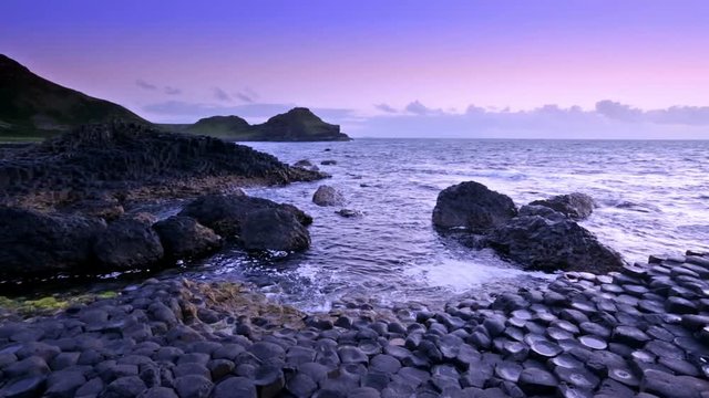 sunset over basalt rocks formation Giant's Causeway known as UNESCO World Heritage Site, County Antrim, Northern Ireland