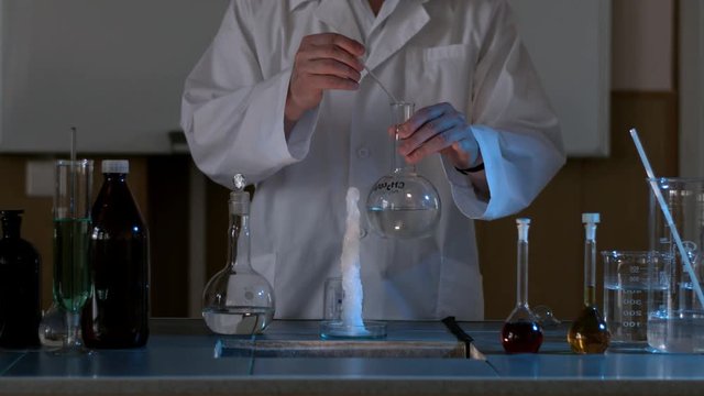 Scientist in a laboratory conducting an experiment on the instantaneous transformation of the liquid into ice. The chemical effect of the liquid or water will instantly freeze